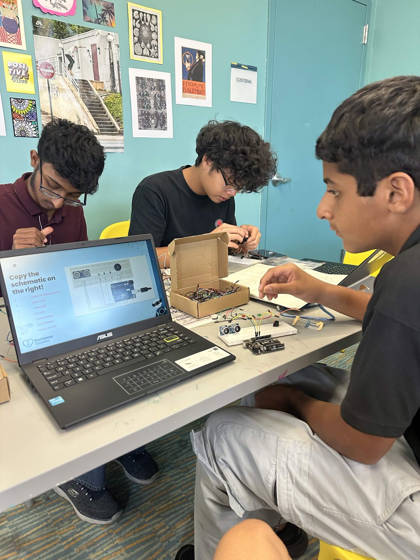 Rockaway Robotics students working on an electronics workshop project together