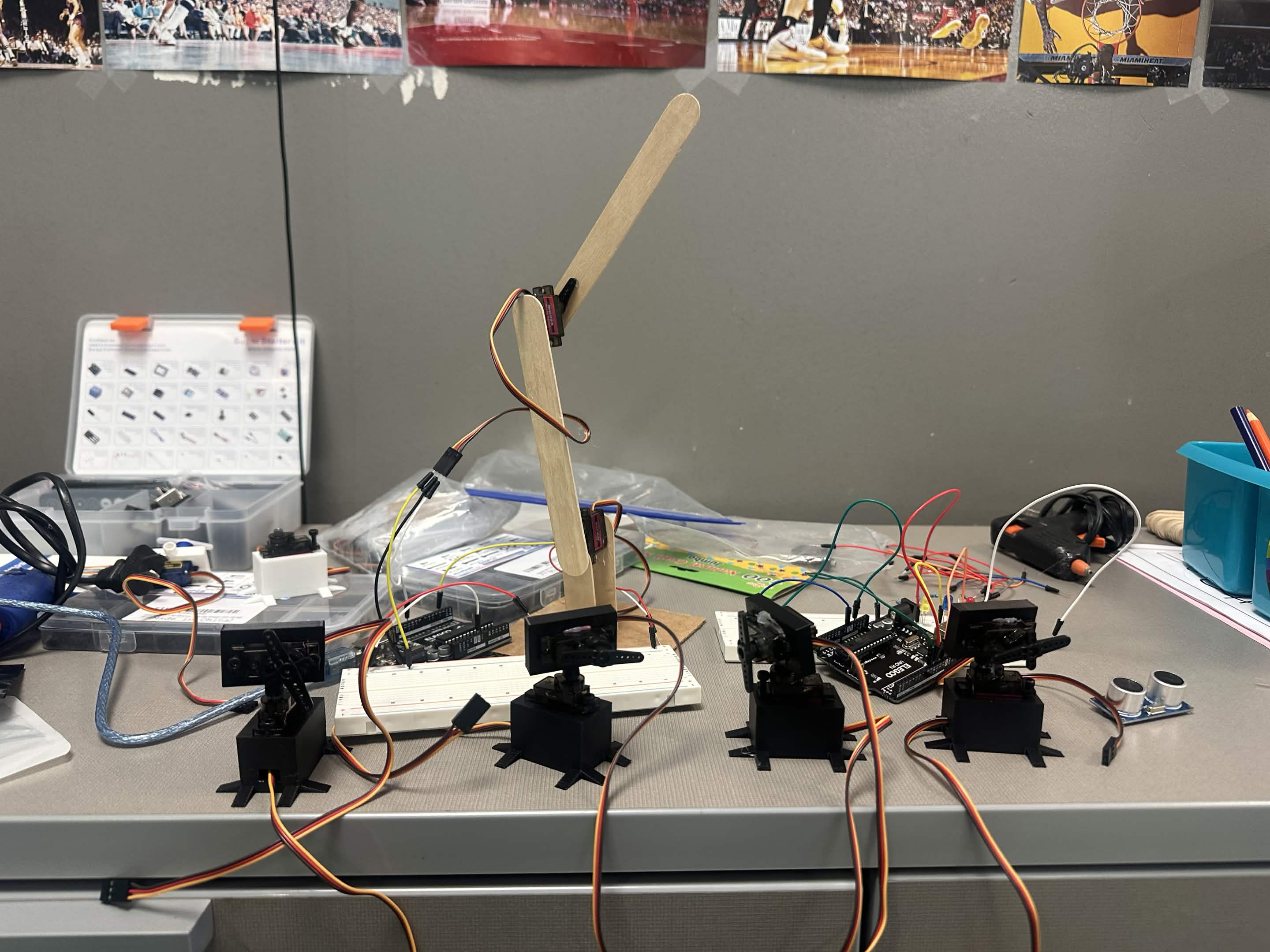 Row of servo motors and a robotic arm project on a desk